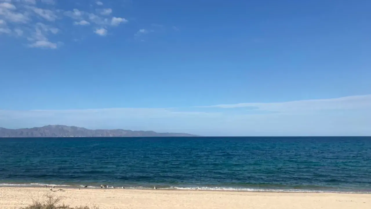 Clouds, sky, sand, sea, and the Cerralvo Island.